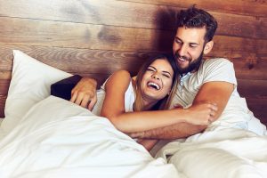 a man and woman lying in bed