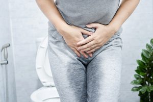 a person holding her crotch