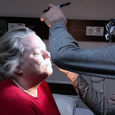 surgeon examining patient for facelift