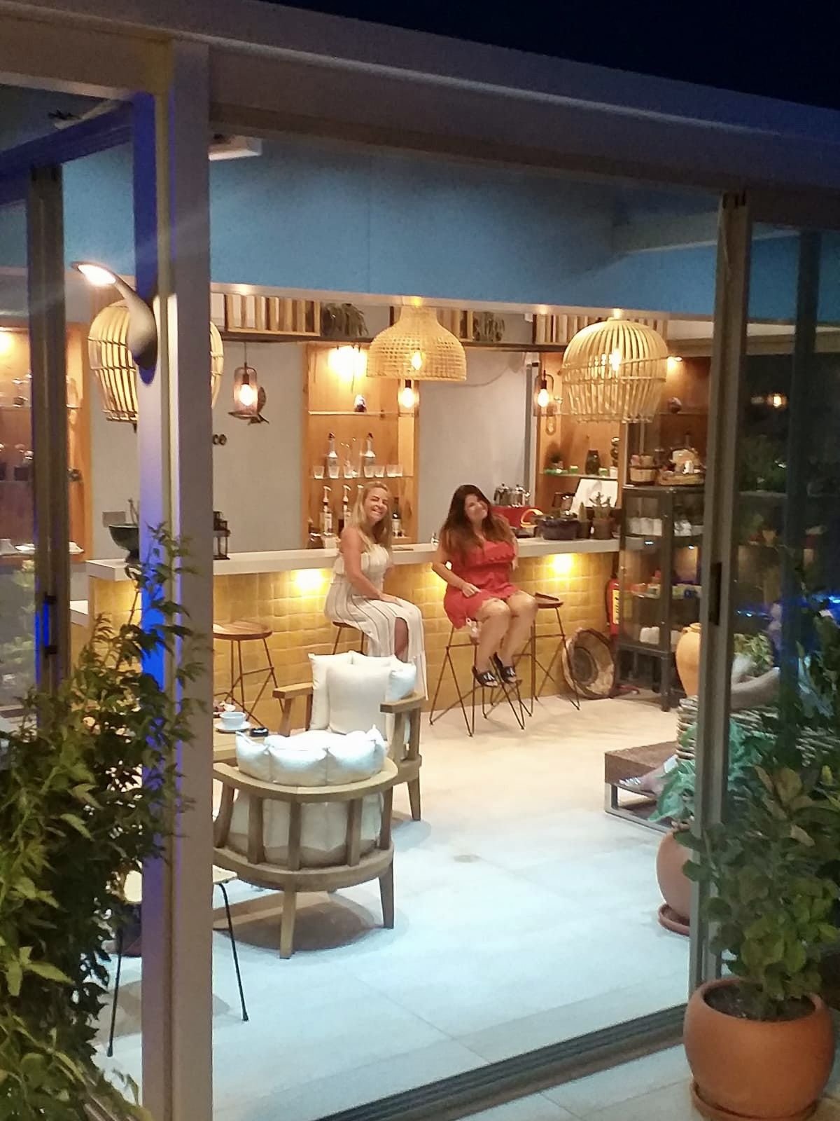 Guests in the glass garden lounge at Mandarin Grove in the evening