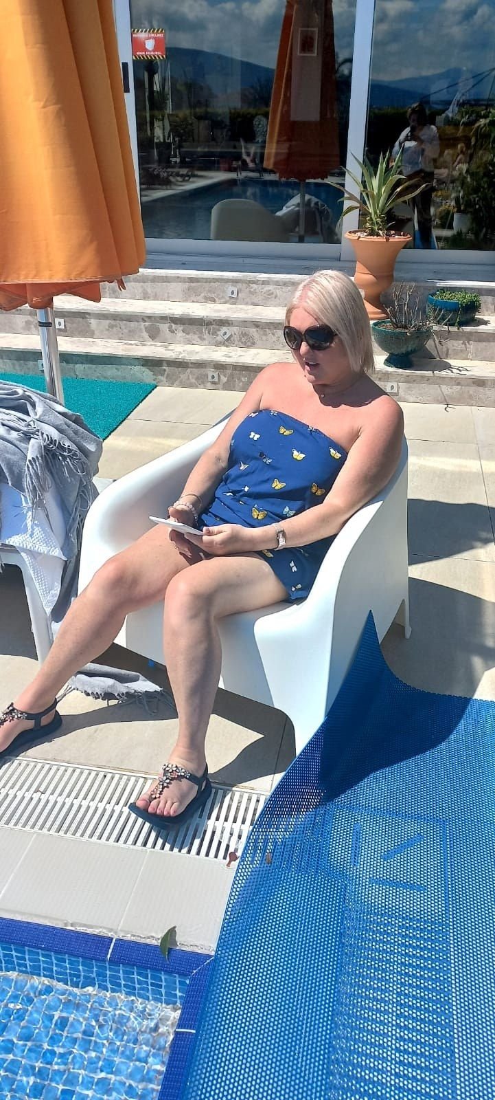 A guest relaxing by the pool