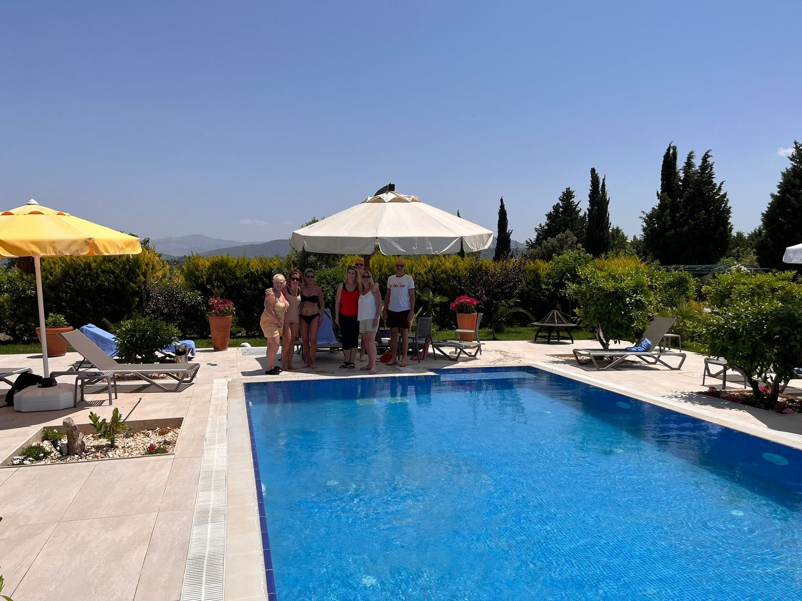 The pool and gardens at Mandarin Grove with the hills of Urla behind